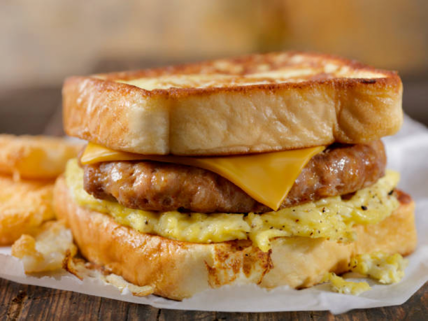 Ultimate French Toast Bun Breakfast Sandwich with Egg, Bacon, Cheese and More